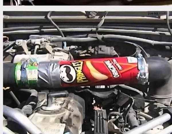 Pringles can duct taped into a car engine as a replacement intake hose.
