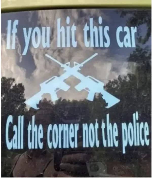 Car window decal with crossed rifles saying call the corner not the police