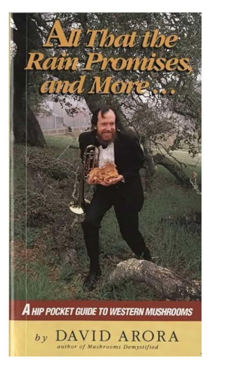 Same mushroom field guide cover of a man in a tuxedo with a trombone in the woods.