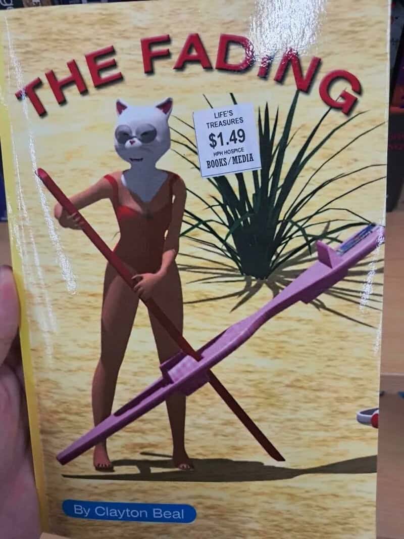 Thrift store copy of The Fading with a cat-headed 3D woman holding a pink contraption.