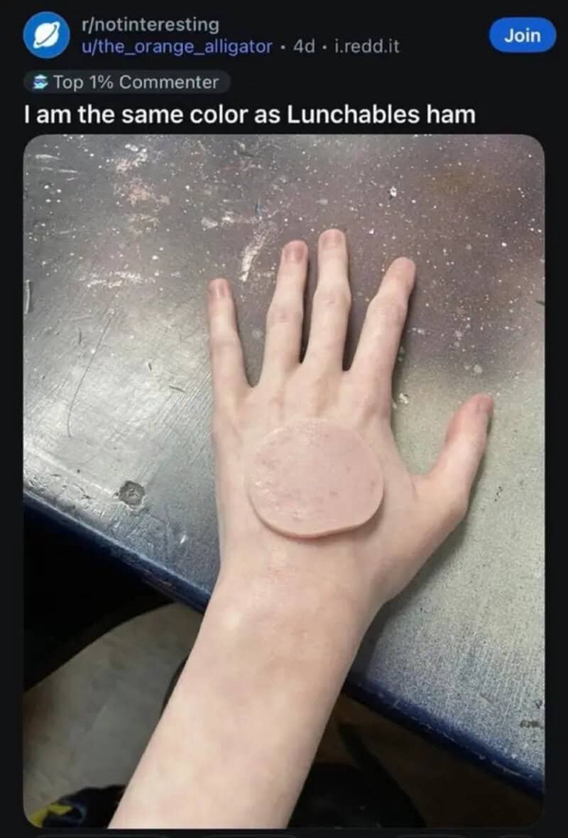 Hand with a slice of Lunchables ham on top, showing a near perfect skin color match