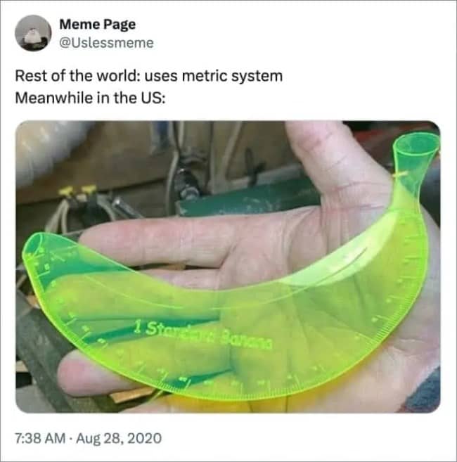 Hand holding a neon green ruler shaped like a banana and labeled one standard banana.