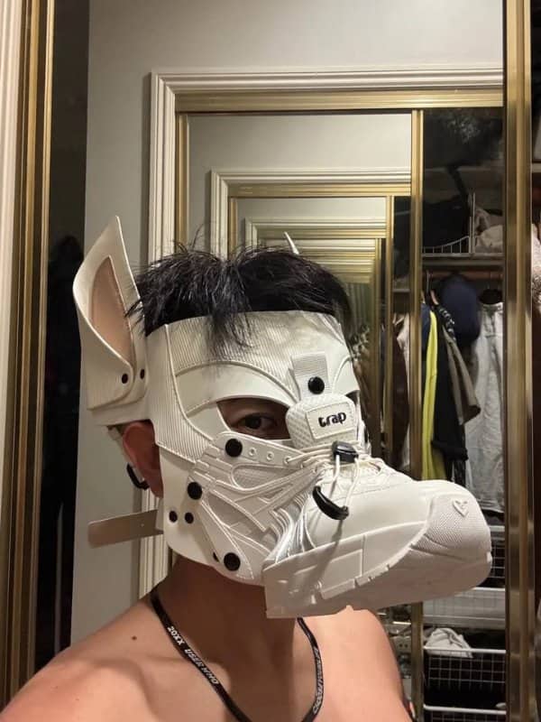 Person wearing a white animal style mask built from a sneaker, with laces and pointed ears