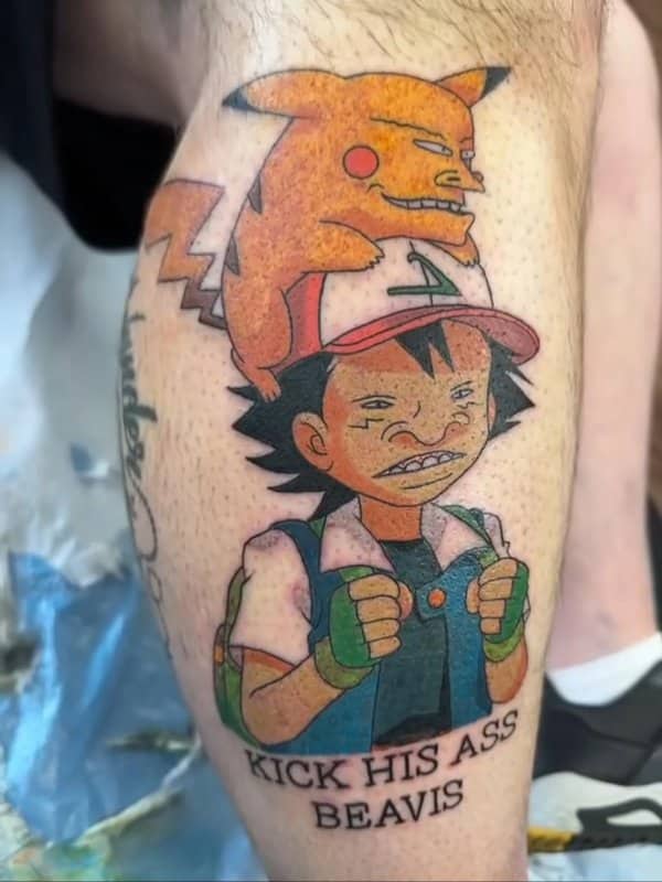 Calf tattoo of Ash and Pikachu redrawn in the Beavis and Butt-Head cartoon style