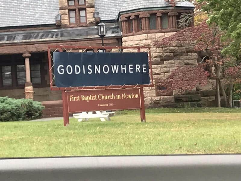 Church sign with no spaces reading GODISNOWHERE outside the First Baptist Church in Newton