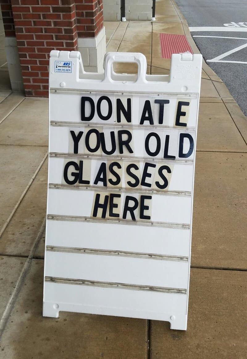 Sidewalk sign with plastic letters spaced to read DON ATE YOUR OLD GLASSES HERE