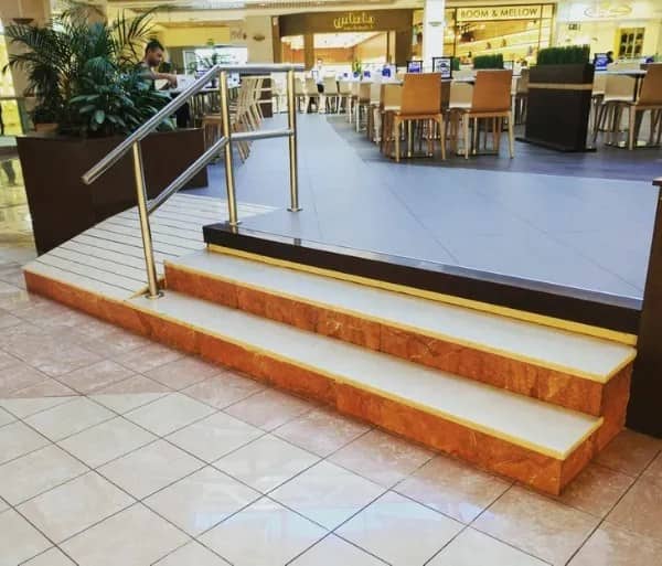 Mall staircase with the metal handrail installed over a small side section instead of the main steps