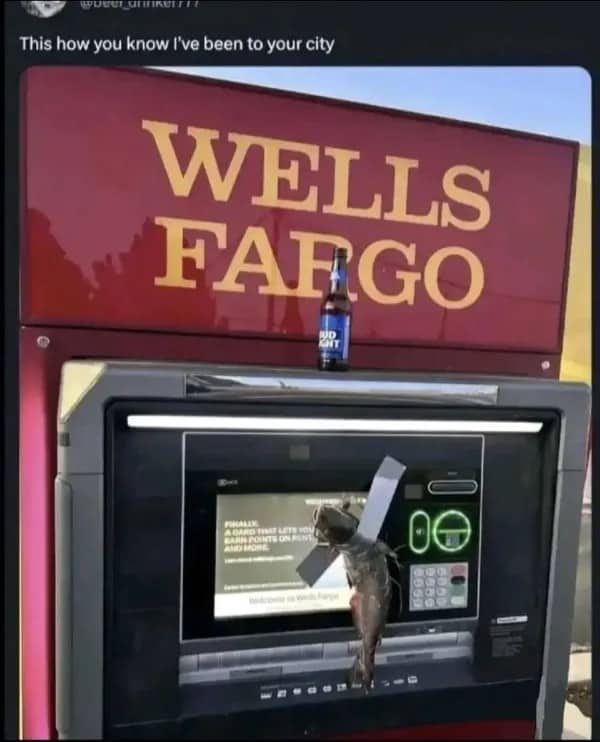 Wells Fargo ATM screen with a fish duct taped to it and a beer bottle on top