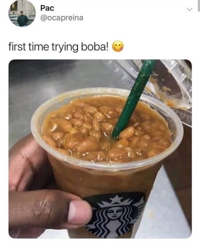 Starbucks cup filled with baked beans and a green straw, captioned first time trying boba.