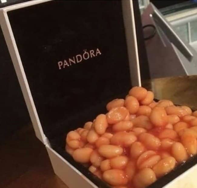 Pandora jewelry box opened to reveal a pile of baked beans instead of a bracelet.