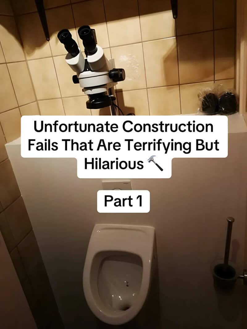 Microscope mounted on a tiled ledge directly above a urinal in a small bathroom.