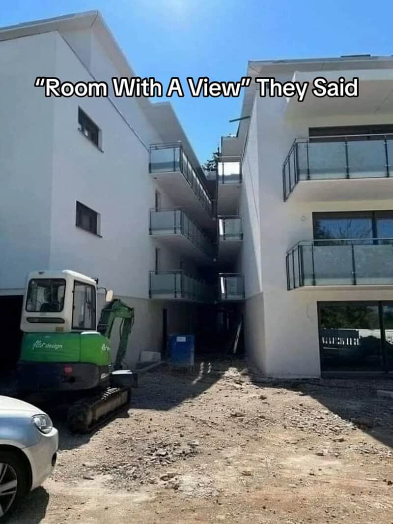 Two new apartment buildings built so close together that their balconies face each other.
