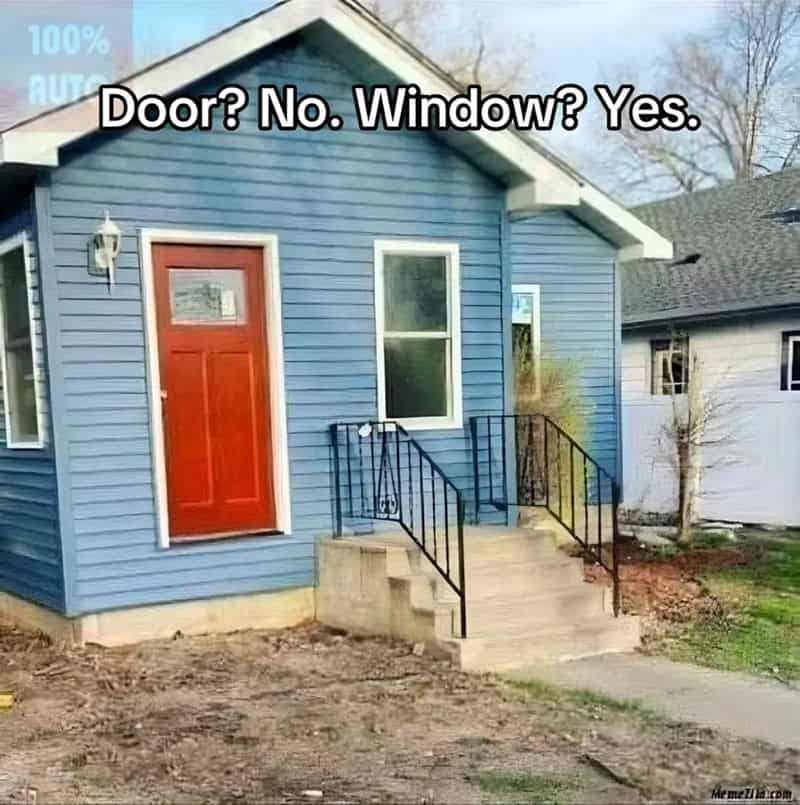 Blue house with concrete stairs and railings leading up to a window while the front door has none.