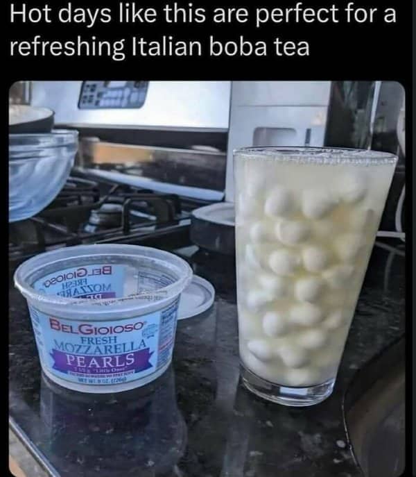 Glass of milk filled with mozzarella pearls next to the cheese tub, called Italian boba.