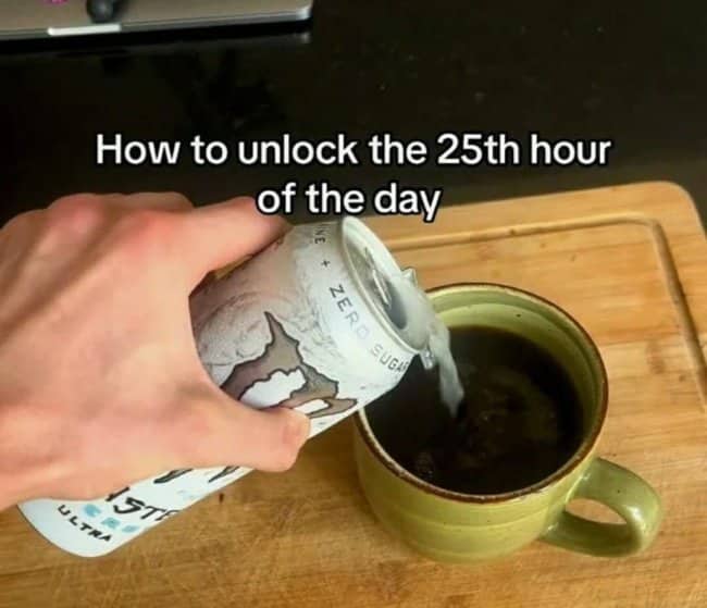 Hand pouring a zero sugar energy drink into a mug of black coffee to unlock an extra hour.