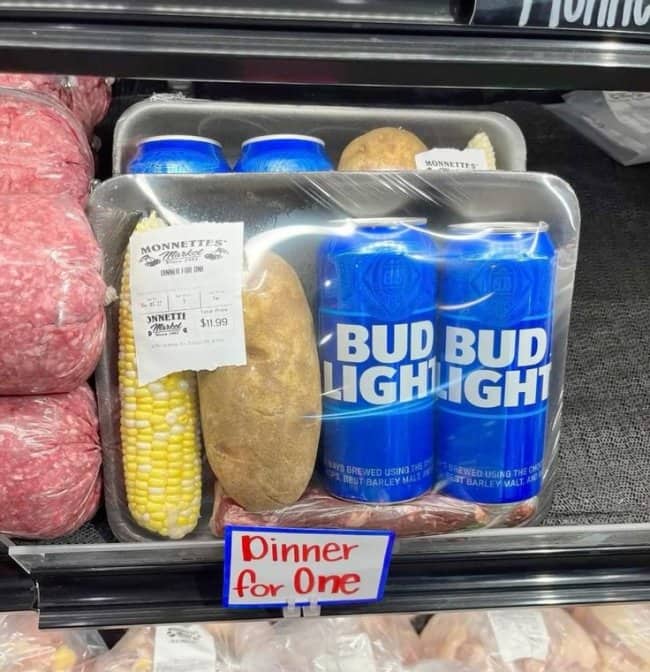 Grocery meal kit labeled dinner for one, with corn, a potato, steak, and two Bud Light cans.