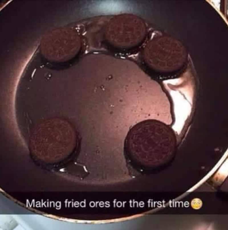 Whole sandwich cookies sitting in a pan of oil, captioned as someone's first fried Oreos.