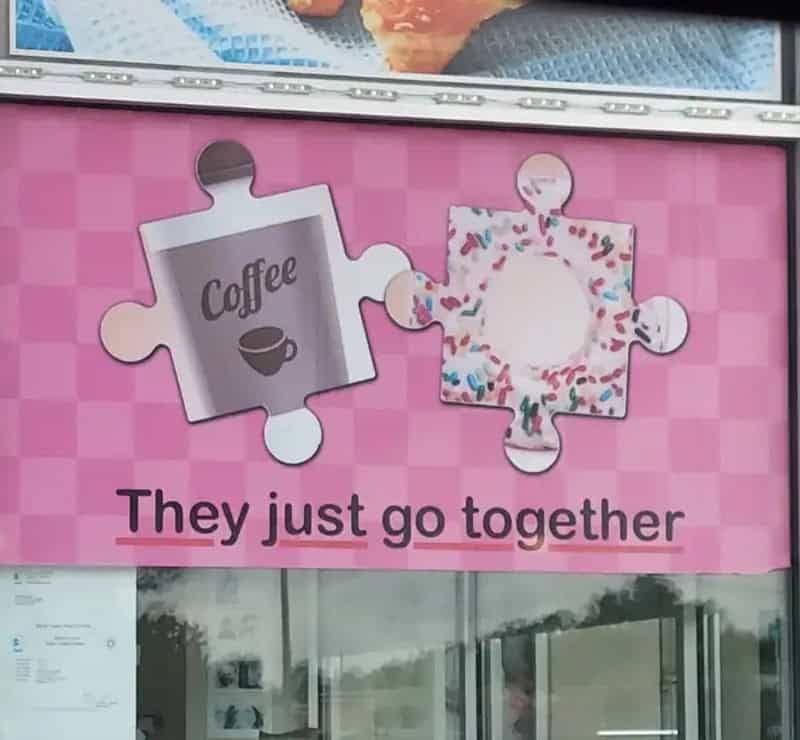 Storefront sign showing coffee and donut puzzle pieces that clearly do not fit together.