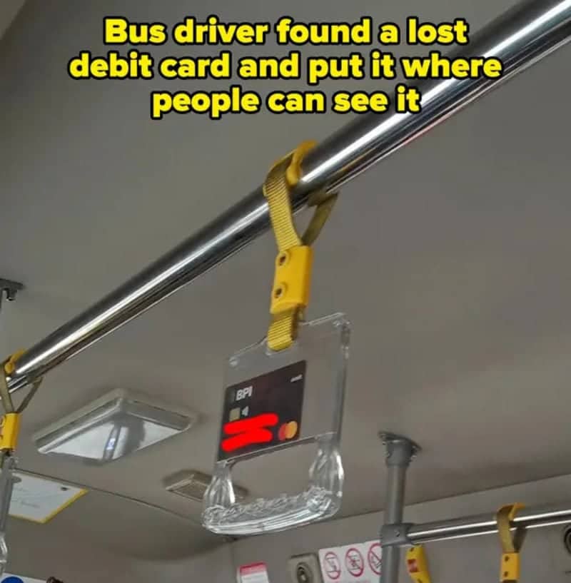 Lost debit card displayed inside a clear bus handle so every passenger can see it.