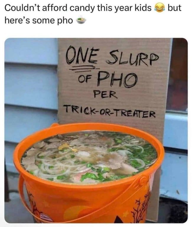 Halloween bucket filled with pho beside a sign offering one slurp per trick-or-treater.