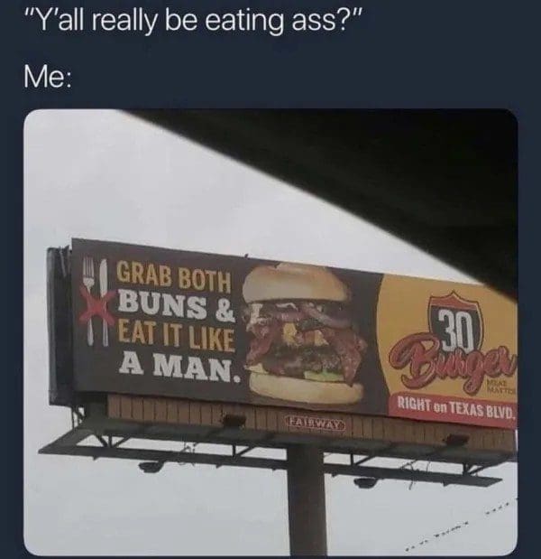 Burger restaurant billboard urging drivers to grab both buns and eat it like a man