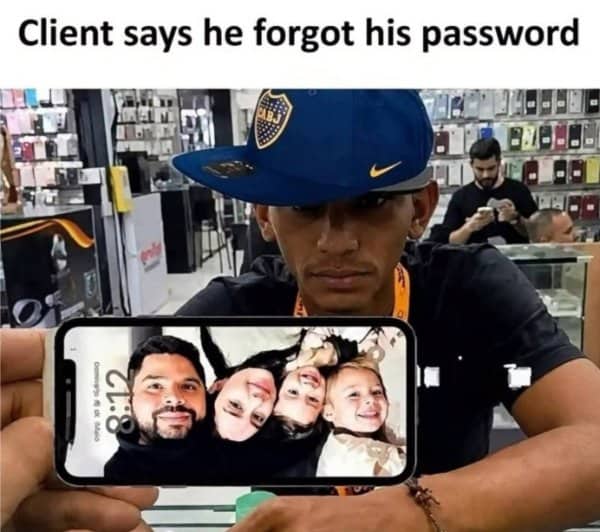 Phone shop worker holding up a customer's phone showing a family lock screen after a forgotten password.