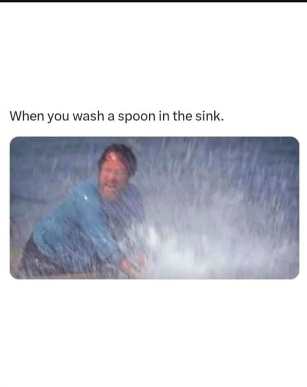 Man drenched by an enormous spray of water, captioned as washing a spoon in the sink.