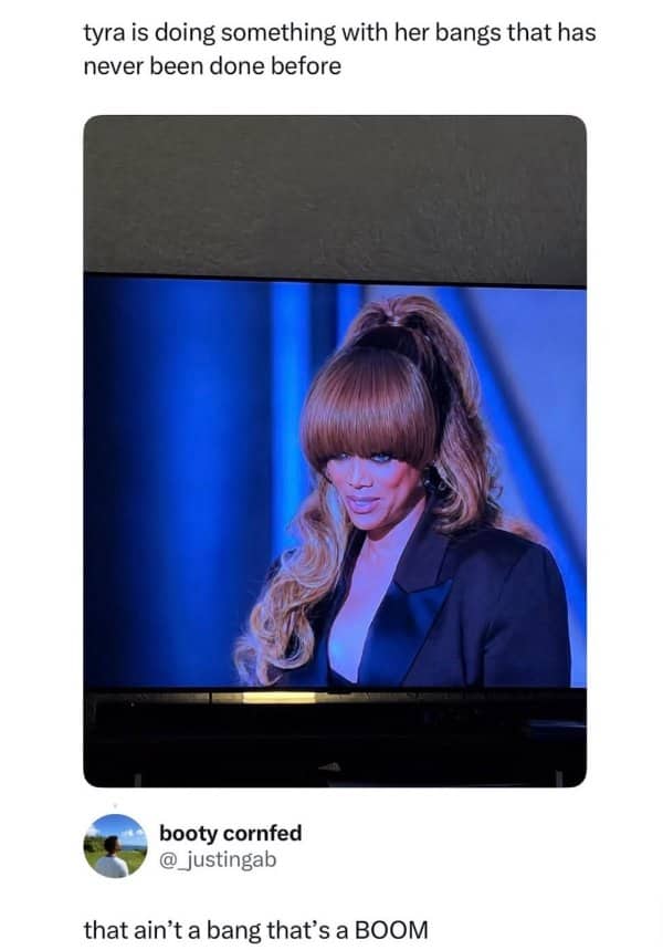 Tweet about Tyra Banks wearing dramatic bangs on TV, with a reply calling them a boom.