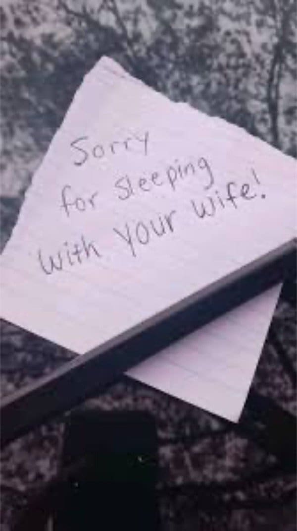 Torn note on a windshield reading sorry for sleeping with your wife.