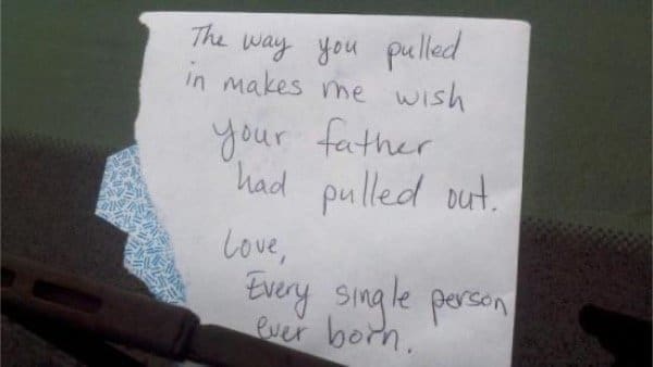 Windshield note insulting someone's parking with a crude joke, signed by everyone ever born.