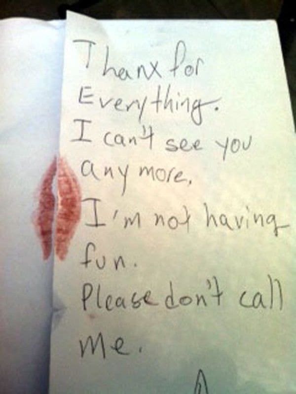 Handwritten breakup note with a lipstick kiss saying thanks for everything and don't call.
