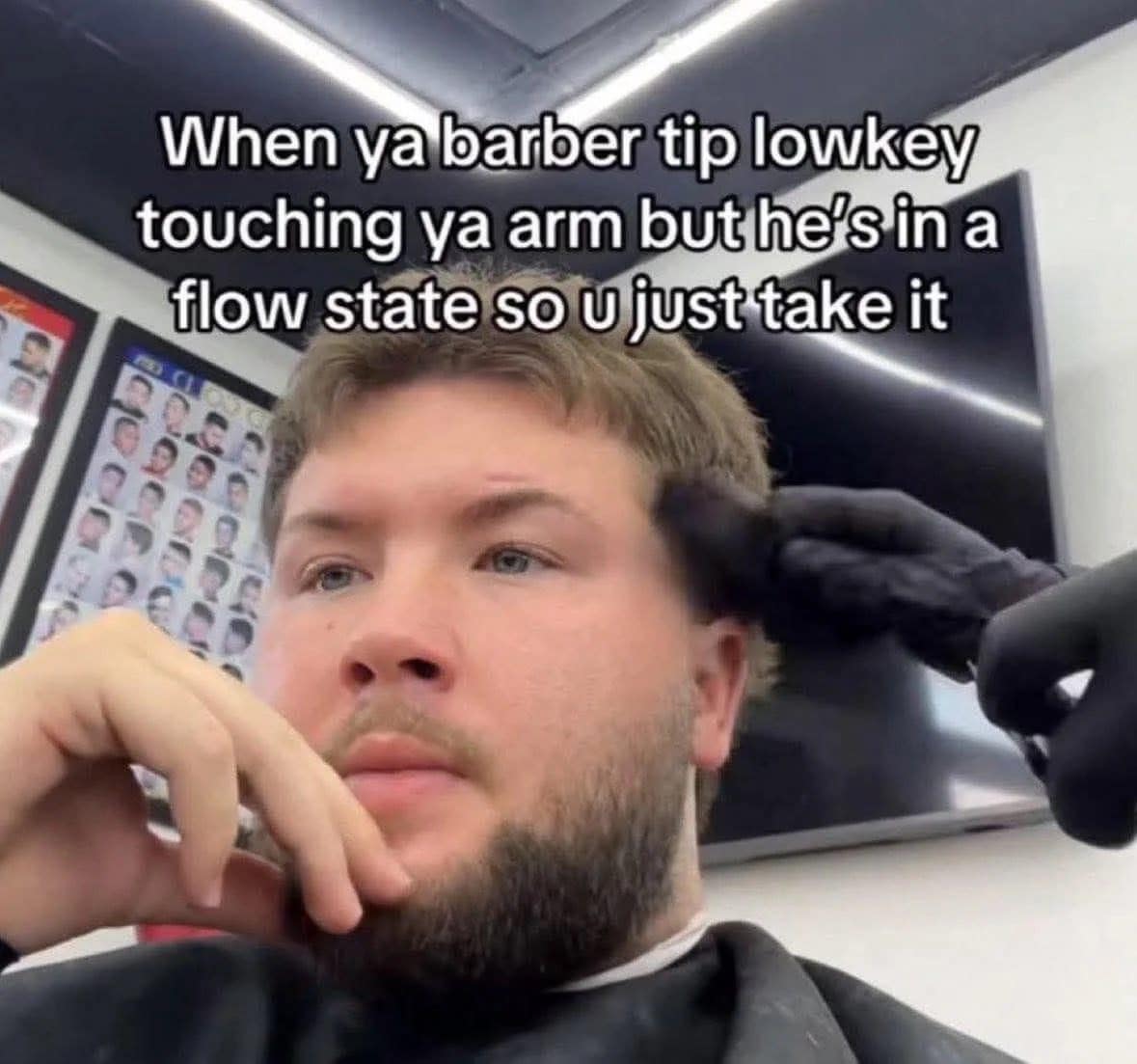 Meme dump favorite: a man at the barber silently tolerating the barber's arm on him
