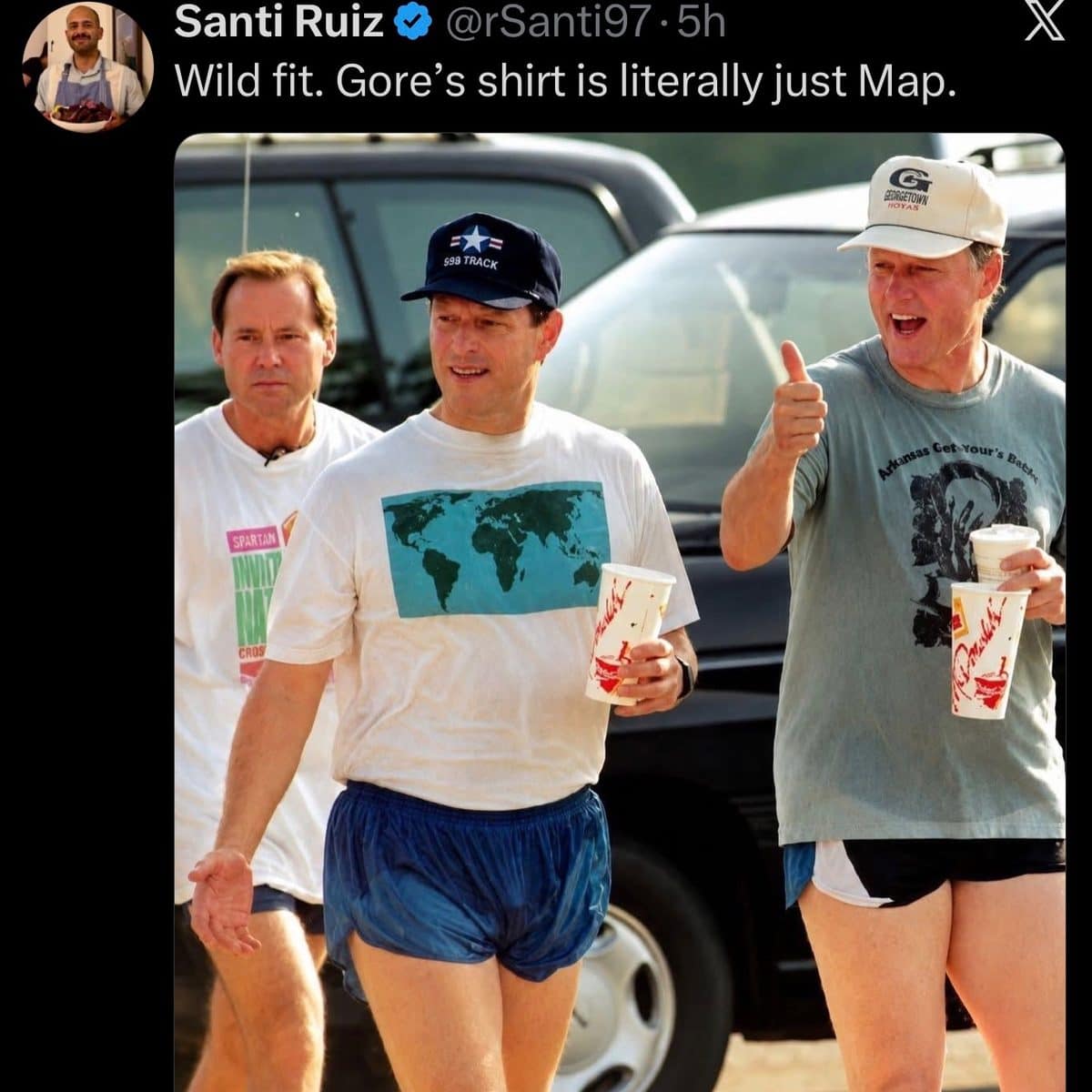Old photo of Al Gore in a world map shirt jogging beside Bill Clinton