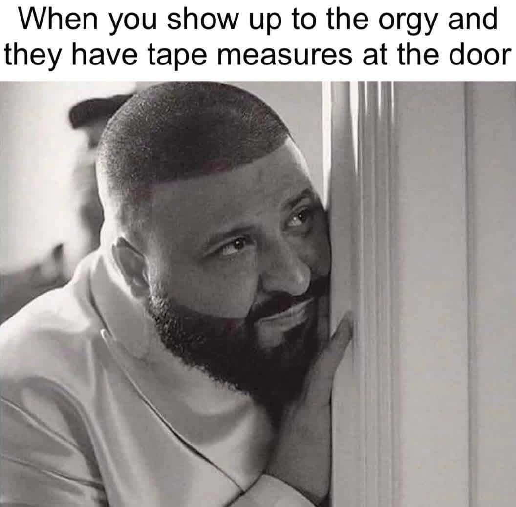 DJ Khaled peeking nervously from behind a door with a crude caption about tape measures.