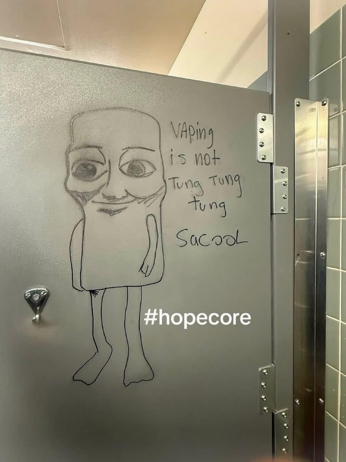Bathroom stall drawing of a cartoon character with an anti-vaping message, tagged hopecore.