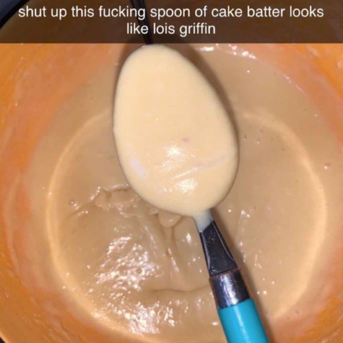 Spoon of cake batter in an orange bowl that supposedly looks like Lois Griffin.