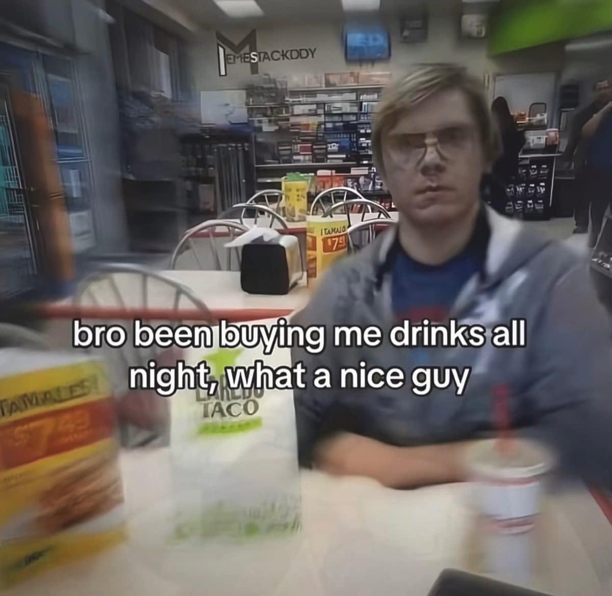 Actor playing a notorious killer at a fast food table, captioned about free drinks.