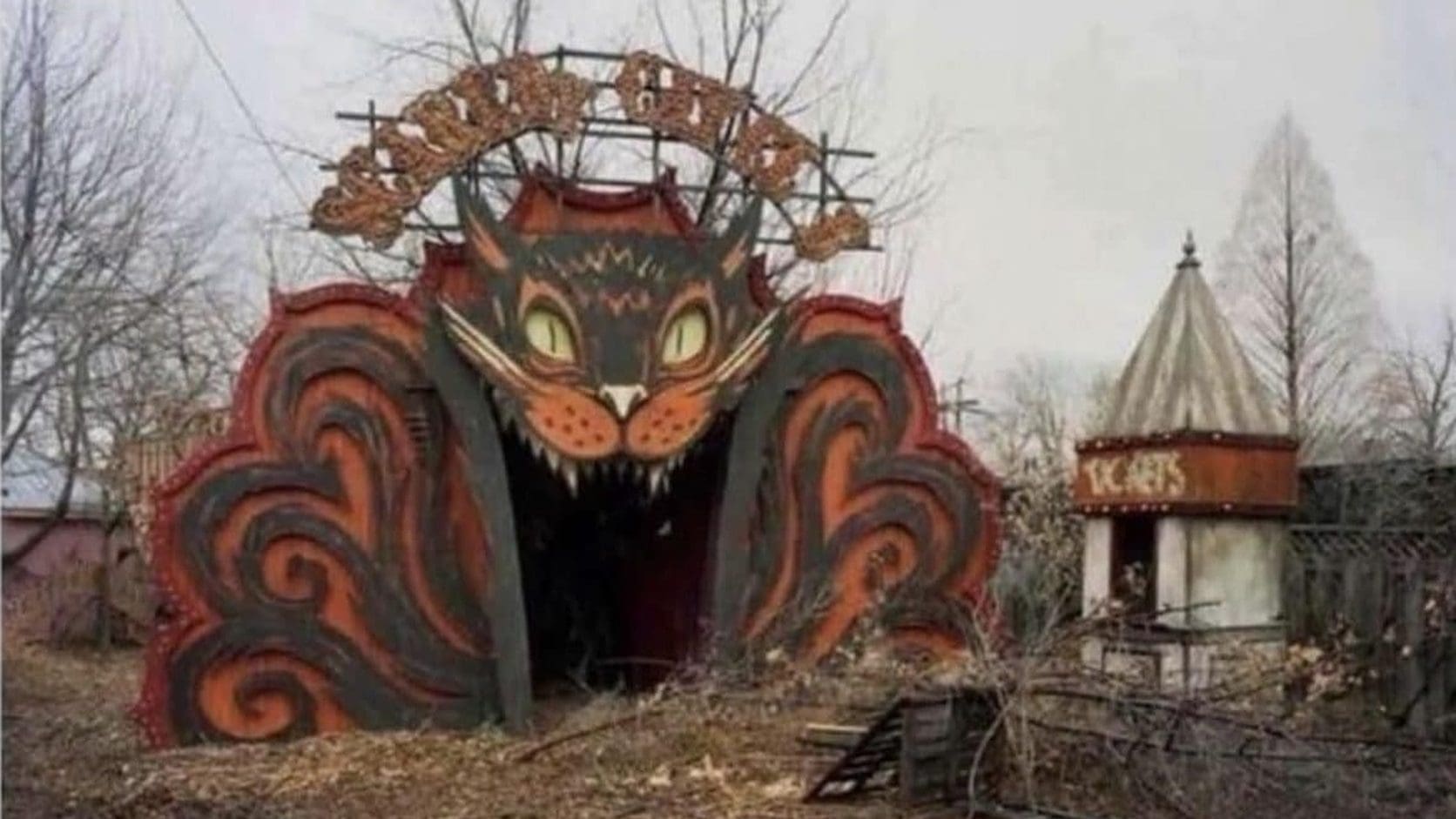 Abandoned amusement park entrance shaped like a giant grinning cat face under a gray sky, the featured pick from today's meme dump.