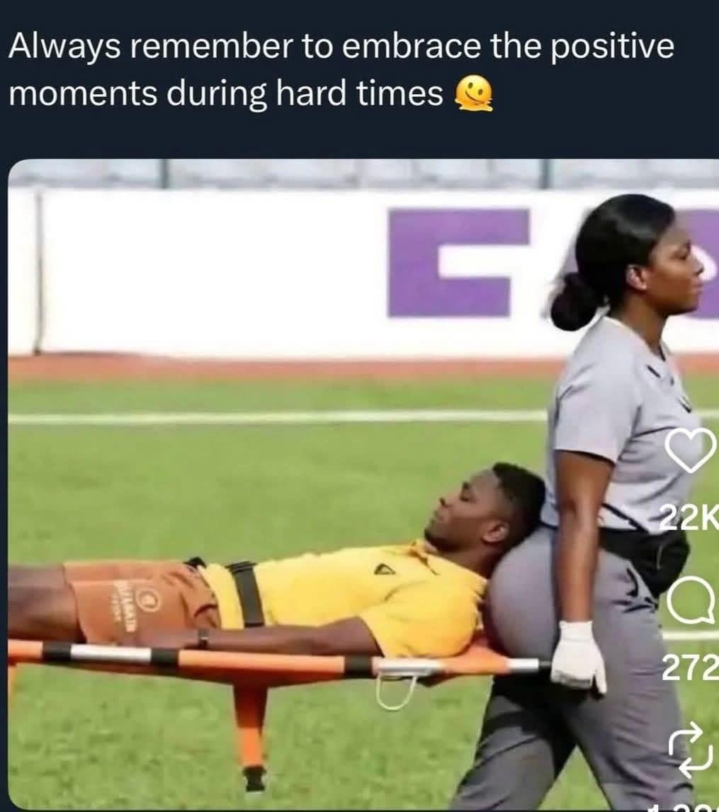 Medic carrying an injured soccer player on a stretcher against her shoulder, captioned embrace positive moments
