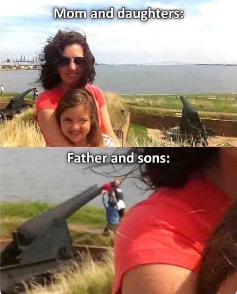 Mom and daughter smiling for a photo while dad and sons climb an old cannon behind them