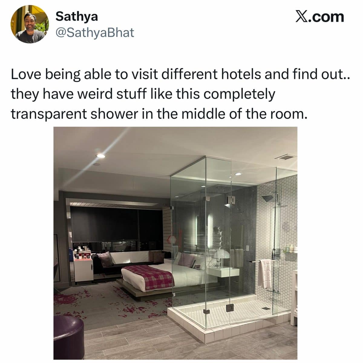 Hotel room with a completely transparent glass shower in the middle of the floor