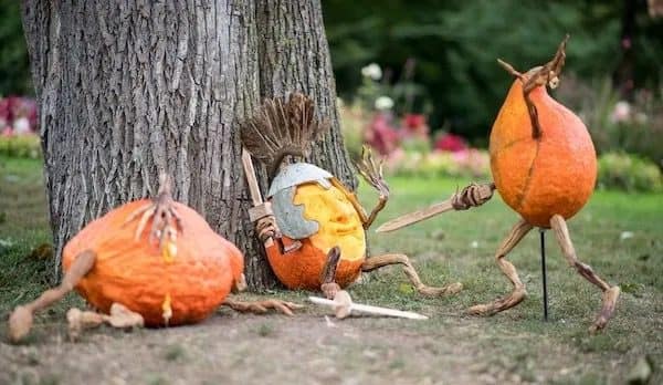 Meme dump pumpkins with stick limbs staged as knights mid sword fight.