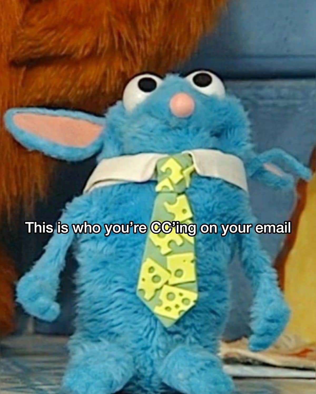 Blue fuzzy puppet in a cheese print tie, labeled as who you CC on emails.