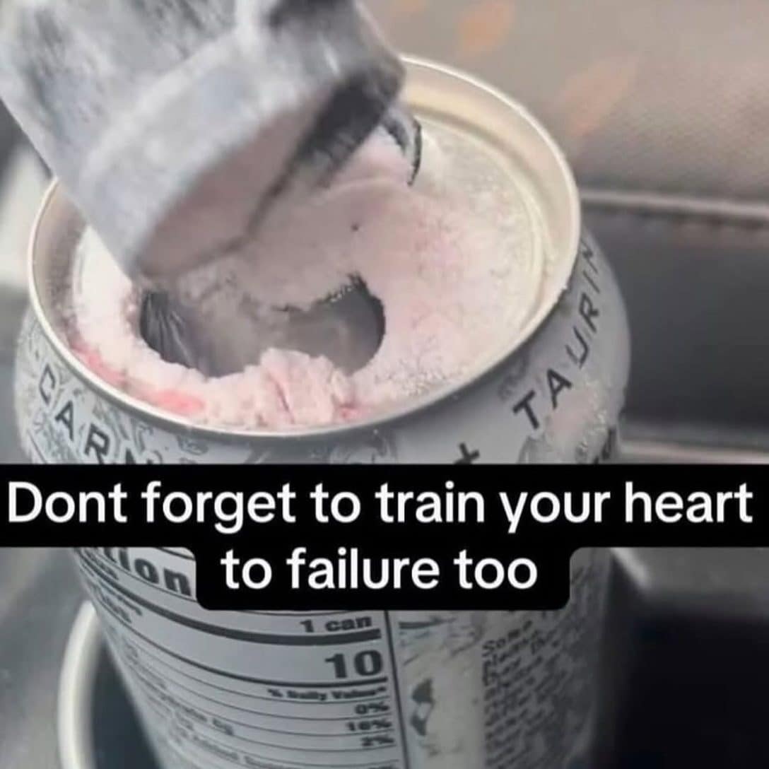 Straw stuck in a frozen energy drink can captioned train your heart to failure too