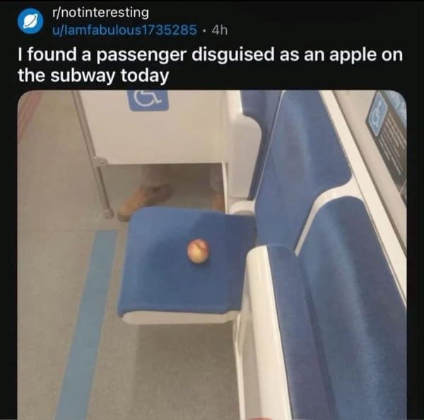 Single apple sitting on a subway seat, joked about as a passenger in disguise.