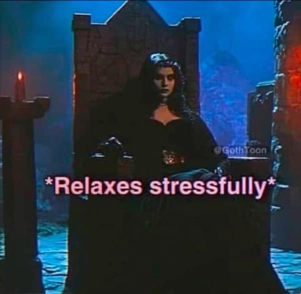 Woman sitting on a dark gothic throne captioned relaxes stressfully in pink text