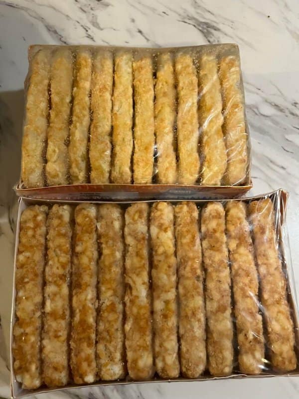 Two trays of frozen hash brown sticks, one visibly shorter, in classic shrinkflation examples.