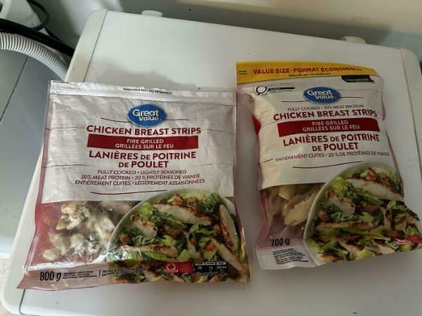 Two Great Value chicken strip bags, with the value size bag holding 700 grams instead of 800.