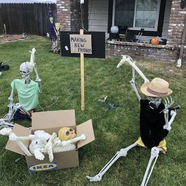 Skeleton crawling out of an IKEA box beside a sign that says making new friends.