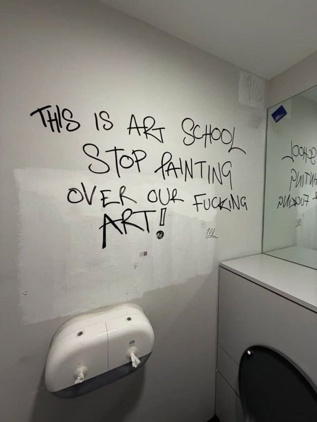 Art school bathroom graffiti begging staff to stop painting over the students' artwork.